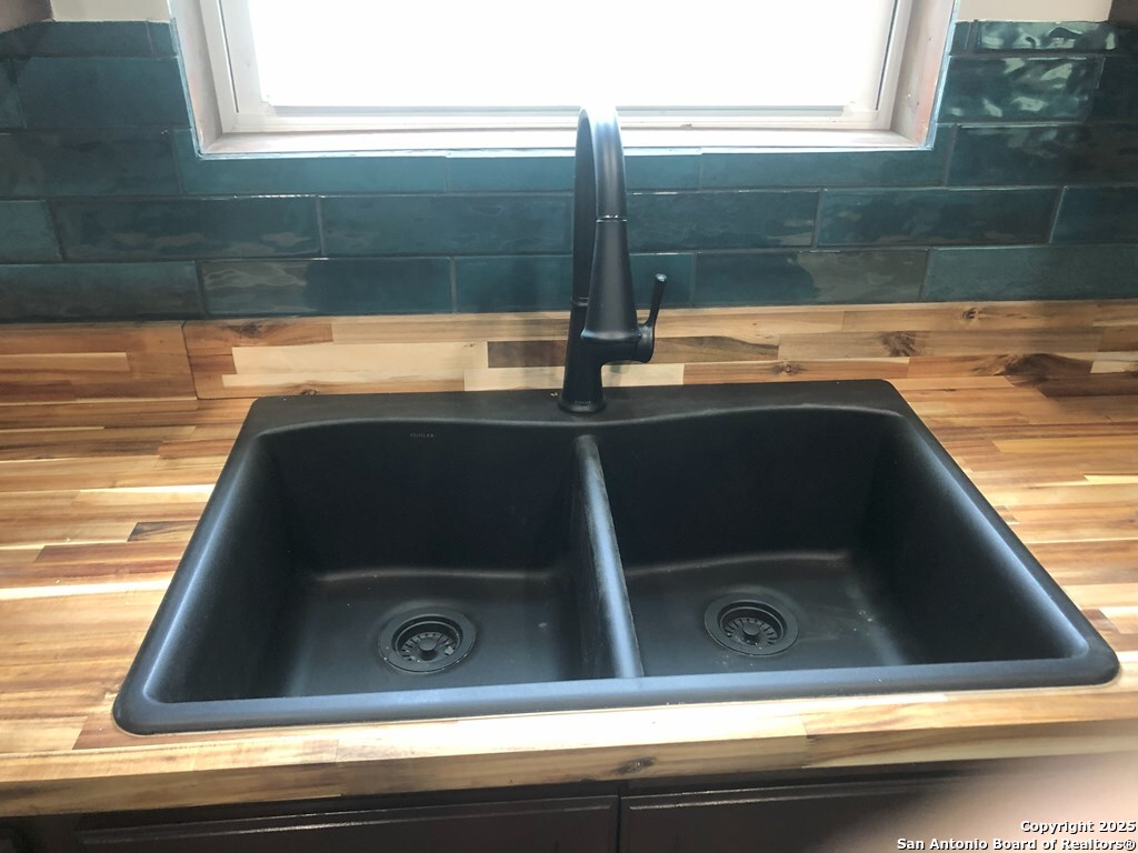 443 Bee Tuleta, TX 78142 - Photo 4 of 27 a close view of sink and mirror