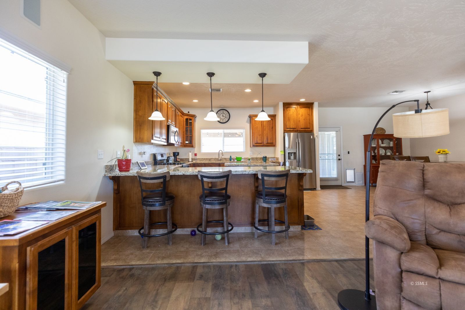 428 South Inyo Street Ridgecrest, CA 93555 - Photo 10 of 33 a view of dining room and livingroom with furniture wooden floor a rug and a chandelier