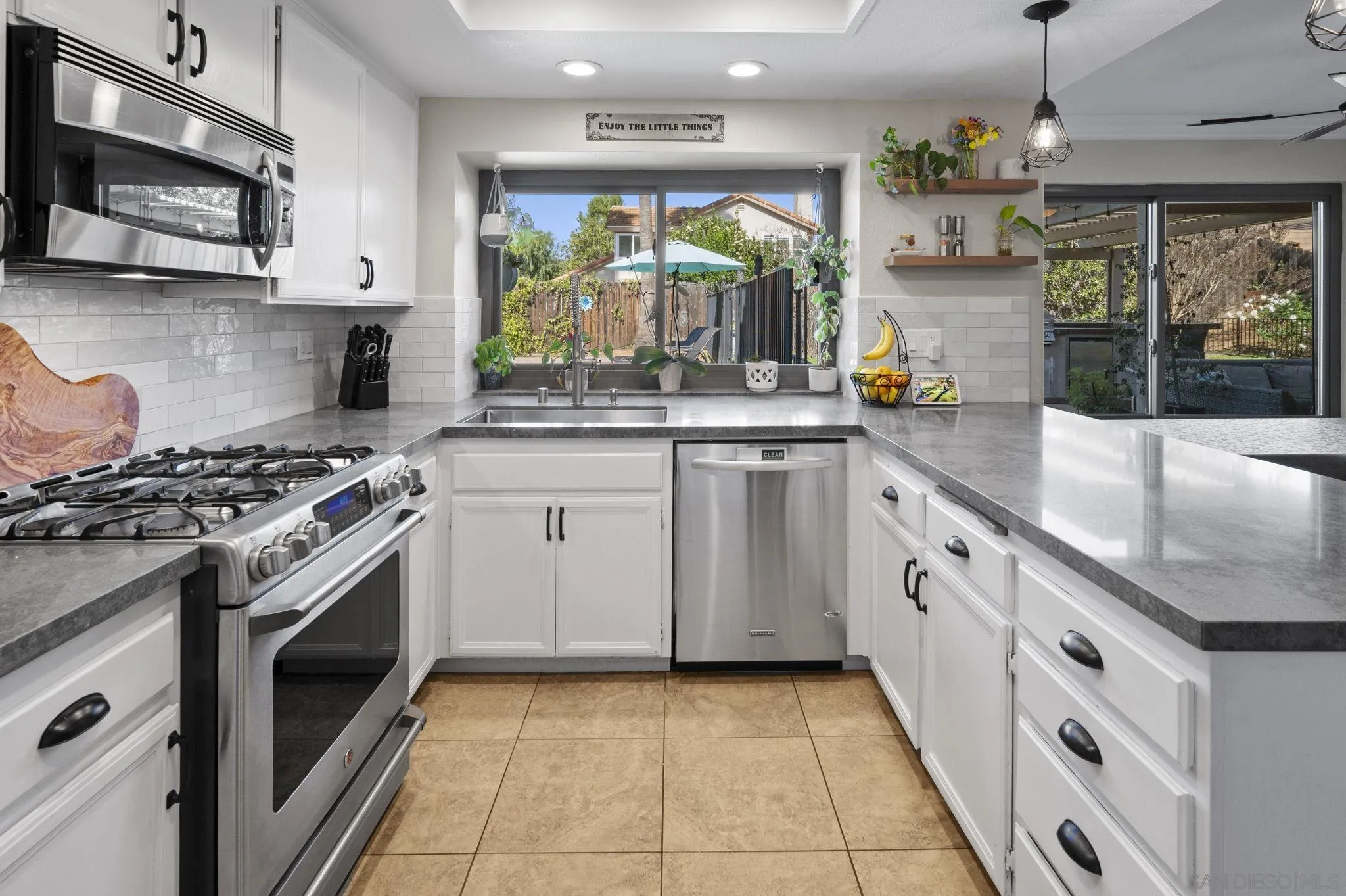13972 Poway Valley Road Poway, CA 92064 - Photo 15 of 59 a kitchen with stainless steel appliances granite countertop a stove a sink and a microwave