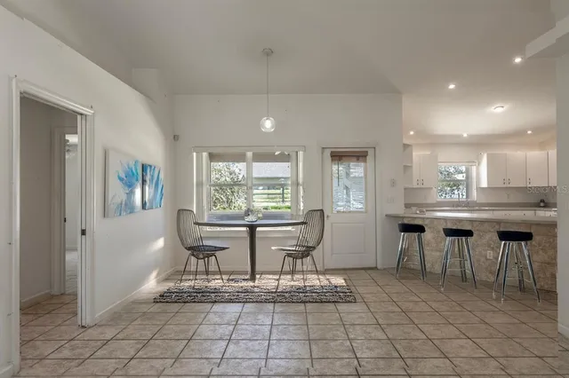 a dining room with furniture and window