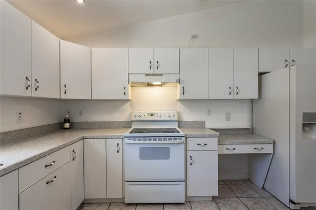 a view of a kitchen with stove and cabinets