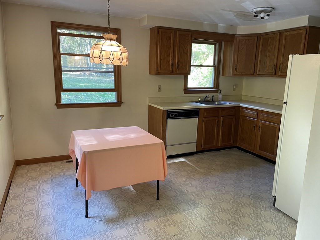 66 Lawton Road, Unit A Shirley, MA 01464 - Photo 3 of 14 a kitchen with granite countertop a sink cabinets and window