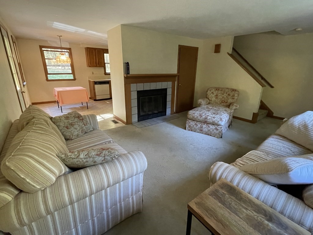 66 Lawton Road, Unit A Shirley, MA 01464 - Photo 5 of 14 a living room with furniture and a fireplace