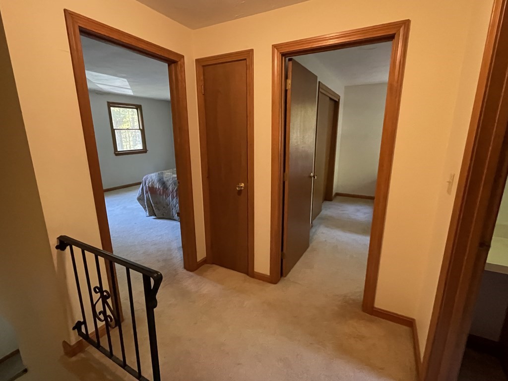 66 Lawton Road, Unit A Shirley, MA 01464 - Photo 8 of 14 a view of a hallway and a livingroom with wooden floor