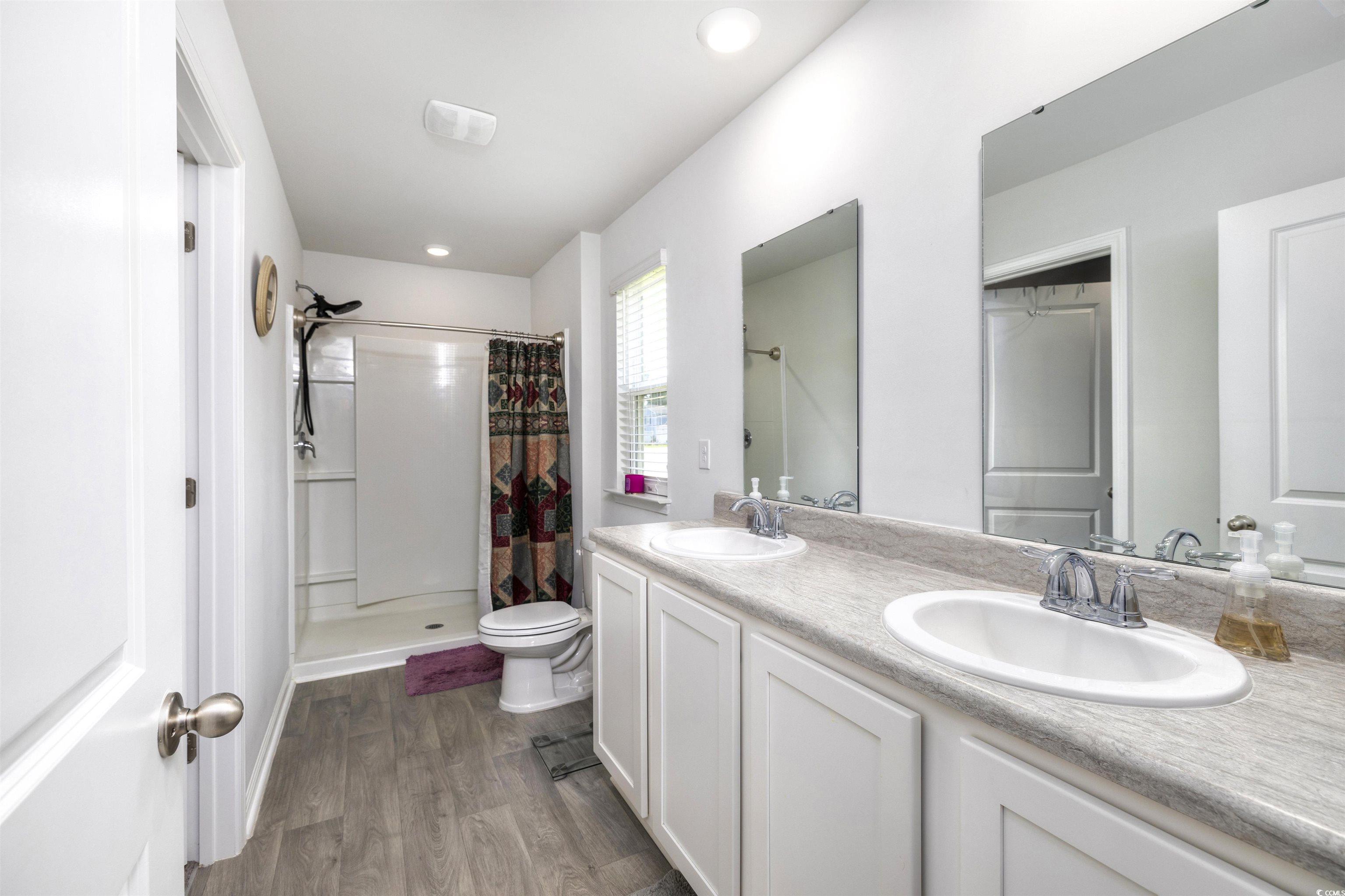 820 Twickenham Loop Longs, SC 29568 - Photo 20 of 38 Bathroom with toilet, wood-type flooring, double s