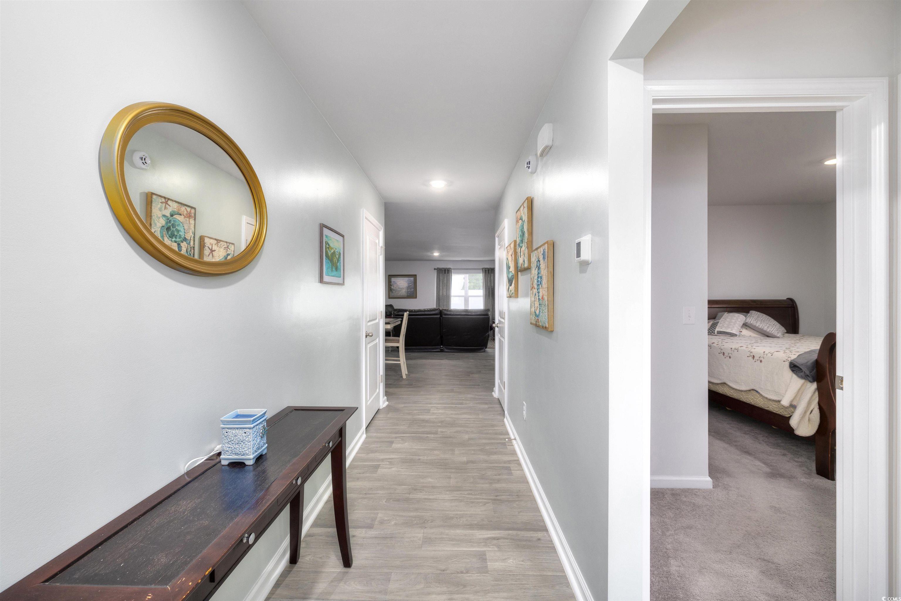 820 Twickenham Loop Longs, SC 29568 - Photo 3 of 38 Corridor featuring light colored carpet