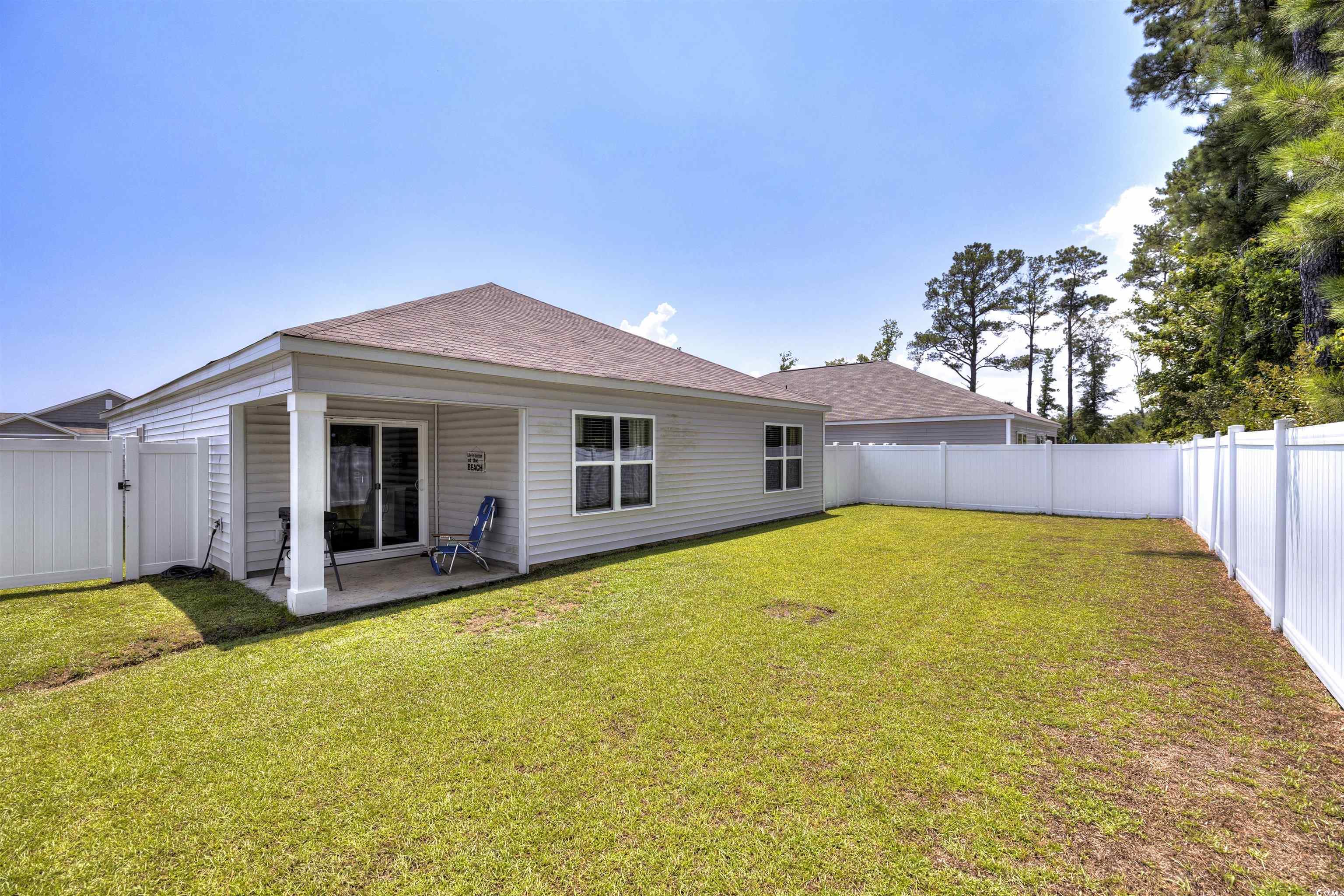 820 Twickenham Loop Longs, SC 29568 - Photo 33 of 38 Rear view of house with a patio area and a lawn