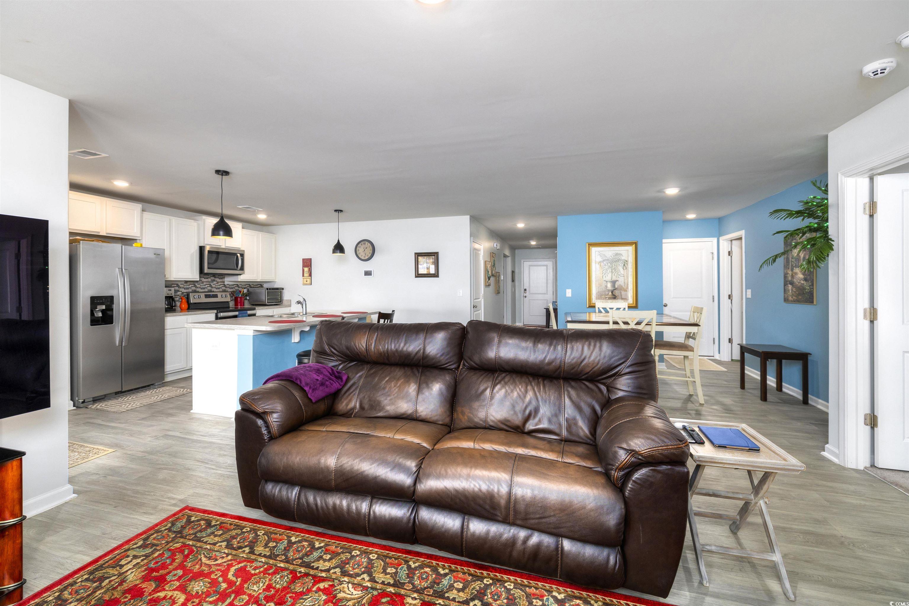 820 Twickenham Loop Longs, SC 29568 - Photo 7 of 38 Living room featuring sink and light hardwood / wo