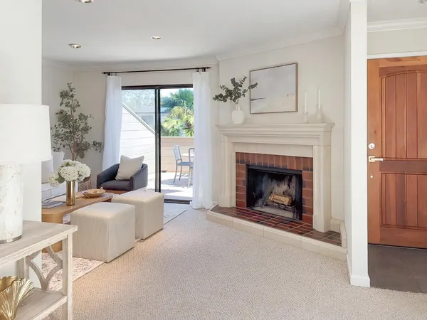 a living room with furniture a window and a fireplace