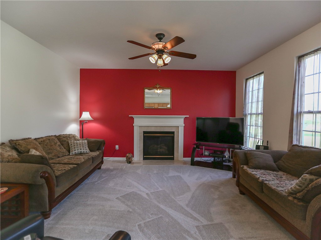 616 Maris Run Webster, NY 14580 - Photo 12 of 29 Family Room highlighted by fireplace.
