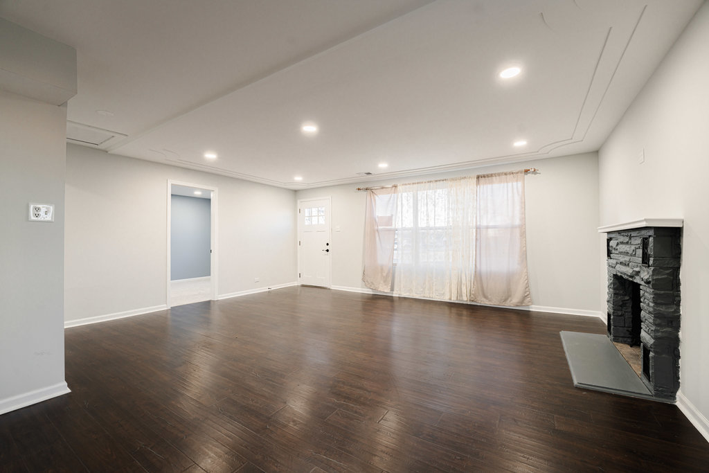 4841 West 119th Street Alsip, IL 60803 - Photo 2 of 33 a view of an empty room with wooden floor and a fireplace