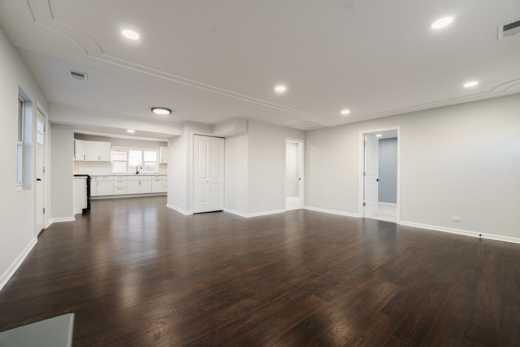 4841 West 119th Street Alsip, IL 60803 - Photo 4 of 33 an empty room with wooden floor and windows