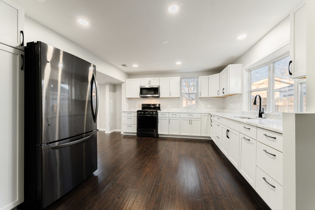 4841 West 119th Street Alsip, IL 60803 - Photo 5 of 33 a kitchen with stainless steel appliances a refrigerator a sink cabinets and wooden floor