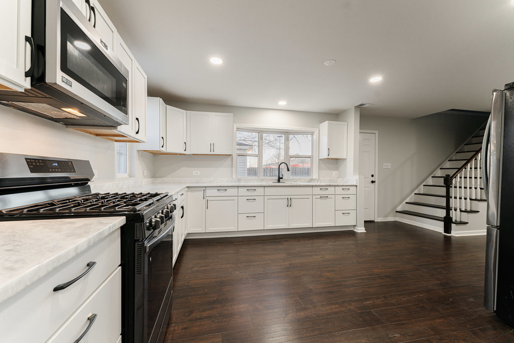 4841 West 119th Street Alsip, IL 60803 - Photo 6 of 33 a kitchen with stainless steel appliances white cabinets and a sink