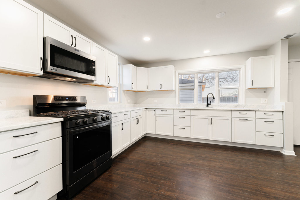 4841 West 119th Street Alsip, IL 60803 - Photo 7 of 33 a kitchen with stainless steel appliances granite countertop a stove a sink and a microwave