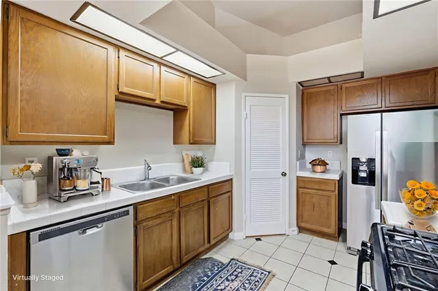 a kitchen with a sink appliances and cabinets