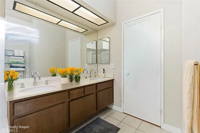 a bathroom with a double vanity sink and mirror