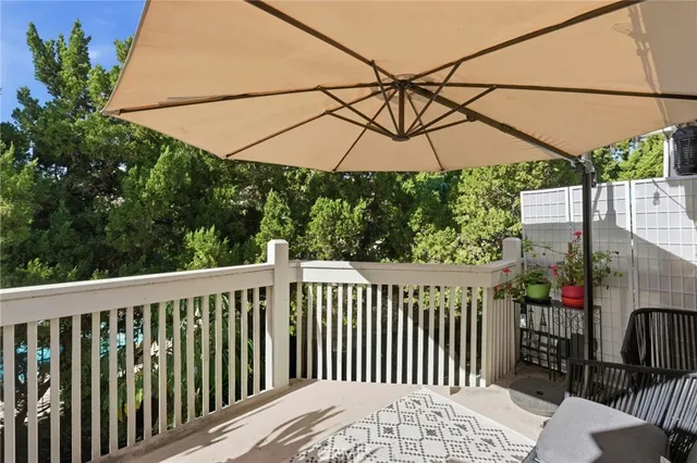 a view of a balcony with wooden fence