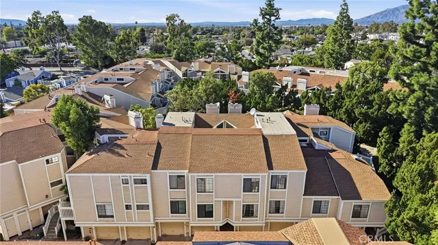 an aerial view of a house with a yard