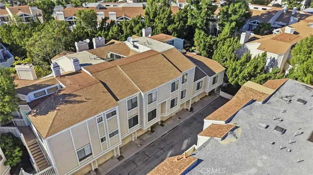 an aerial view of a house with a yard