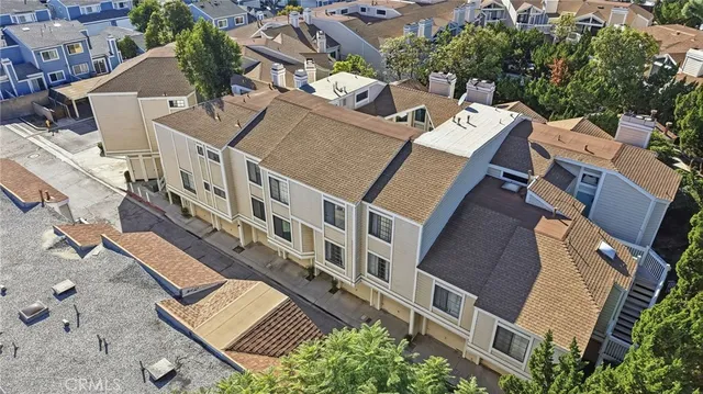 an aerial view of residential houses with outdoor space