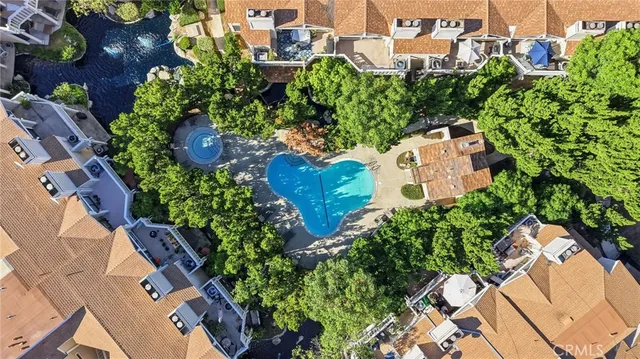 an aerial view of residential houses with city view