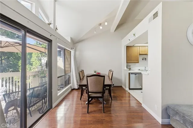 a view of a dining room with furniture a chandelier and wooden floor