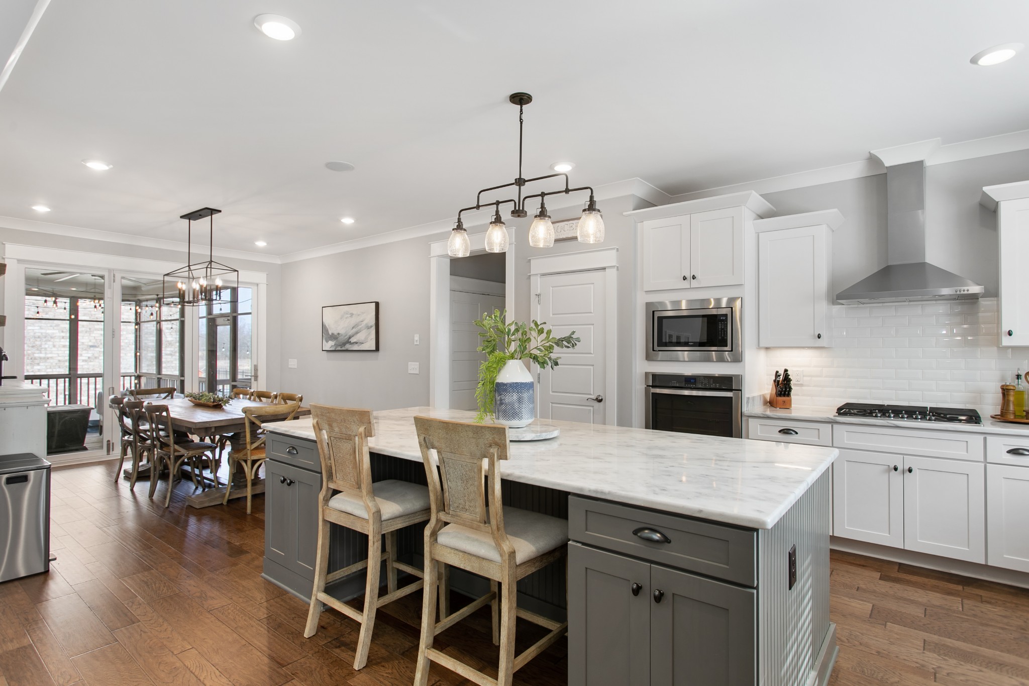 700 Beamon Drive Franklin, TN 37064 - Photo 14 of 47 a kitchen with stainless steel appliances a dining table chairs stove and white cabinets