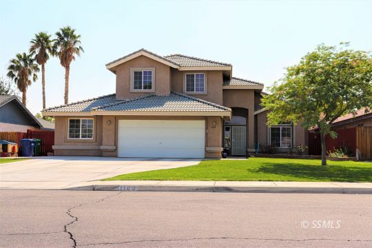 1109 Rebecca Avenue Ridgecrest, CA 93555 - Photo 1 of 50 a front view of a house with a yard and garage