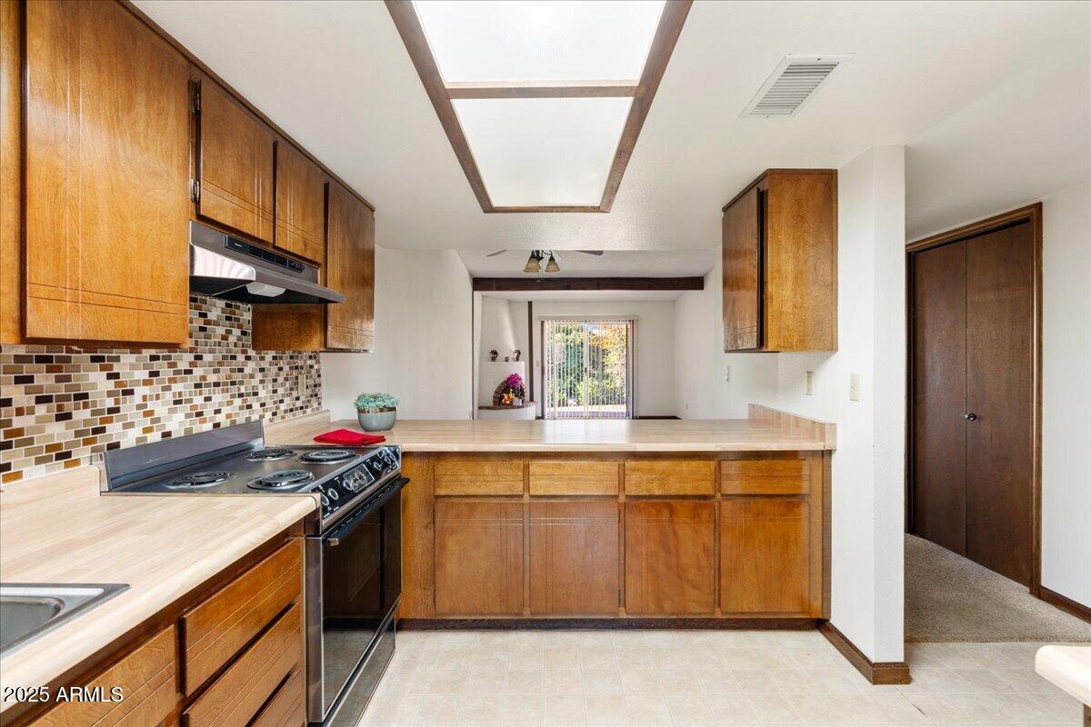 130 Castle Rock Road, Unit 83 Sedona, AZ 86351 - Photo 12 of 32 a kitchen with a sink stove and cabinets