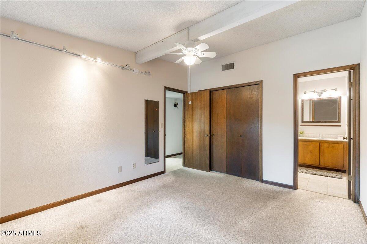 130 Castle Rock Road, Unit 83 Sedona, AZ 86351 - Photo 20 of 32 a view of a livingroom with a chandelier fan and windows