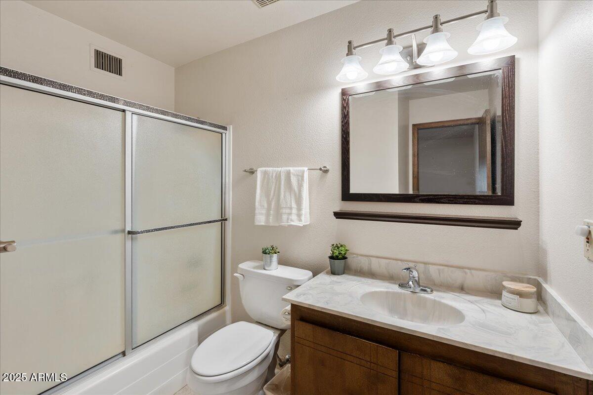 130 Castle Rock Road, Unit 83 Sedona, AZ 86351 - Photo 21 of 32 a bathroom with a granite countertop sink toilet a mirror and shower