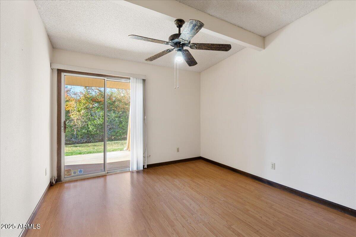 130 Castle Rock Road, Unit 83 Sedona, AZ 86351 - Photo 23 of 32 a view of an empty room with wooden floor and a window
