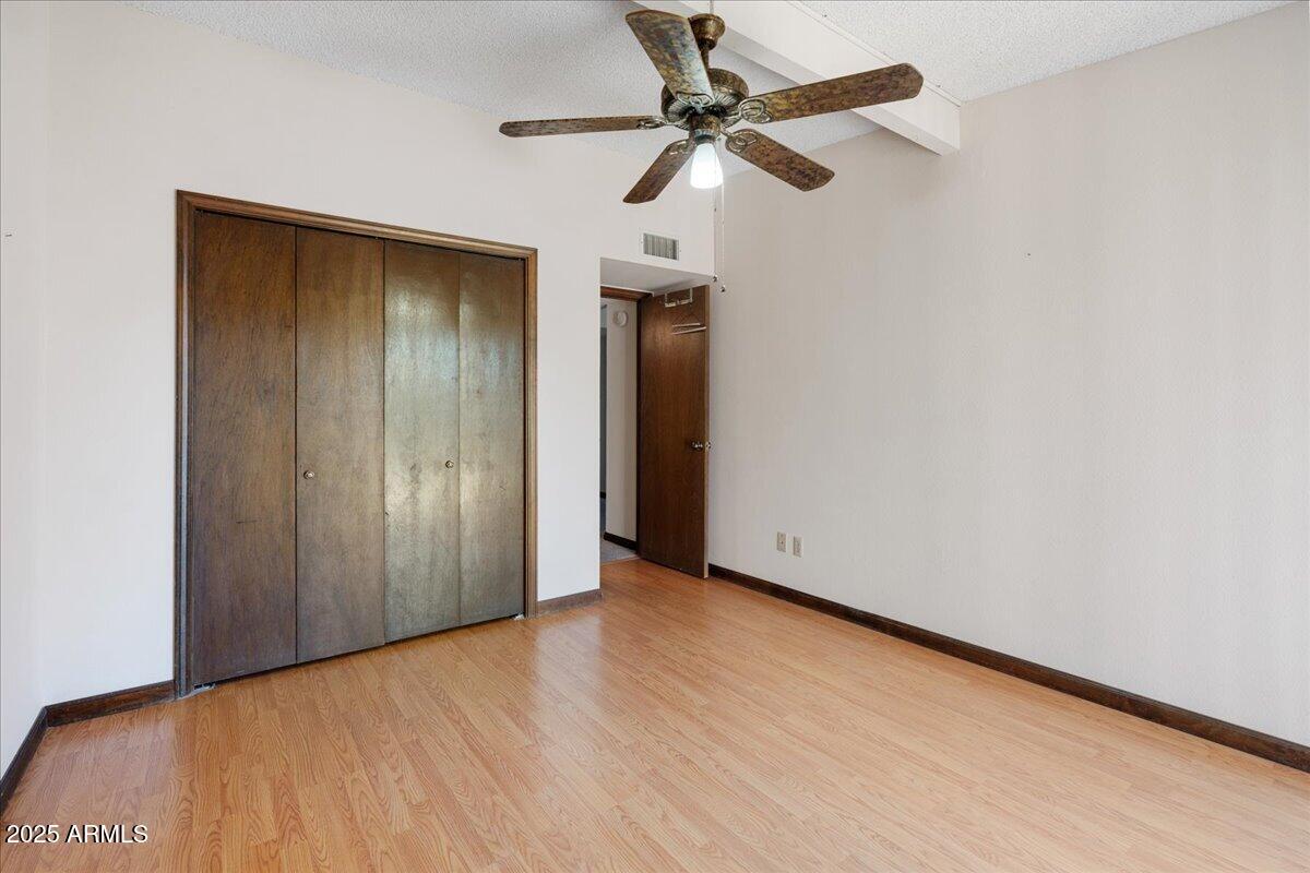 130 Castle Rock Road, Unit 83 Sedona, AZ 86351 - Photo 25 of 32 an empty room with a ceiling fan and a window