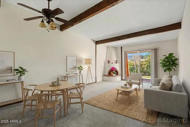 a living room with furniture a chandelier fan and a window