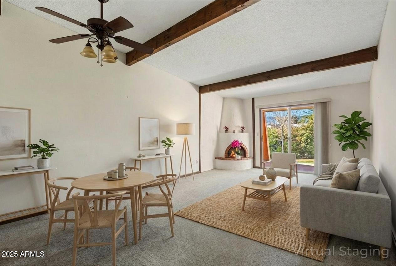 130 Castle Rock Road, Unit 83 Sedona, AZ 86351 - Photo 4 of 32 a living room with furniture a chandelier fan and a window
