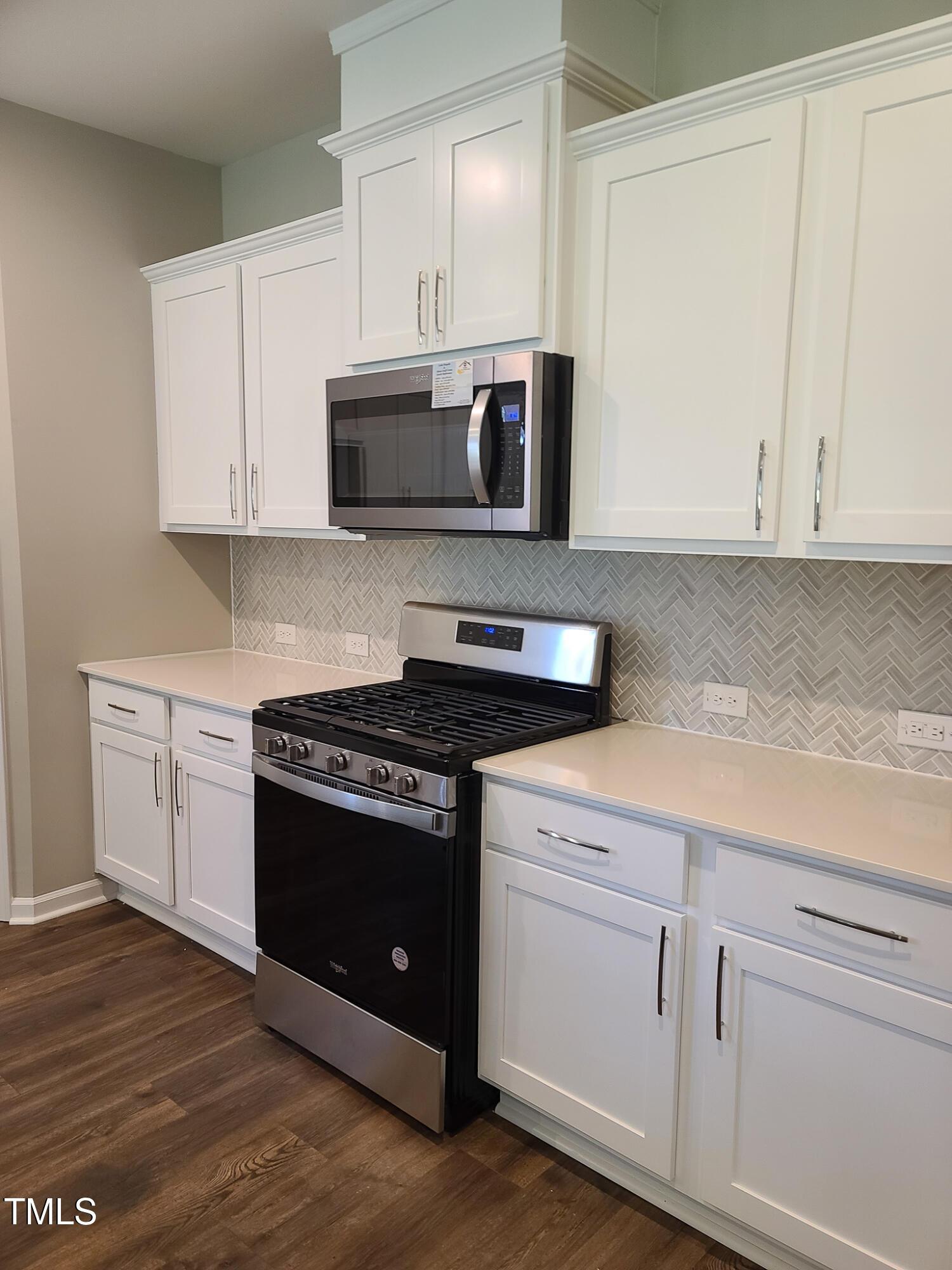 154 Black Cloud Drive Louisburg, NC 27549 - Photo 11 of 28 a kitchen with cabinets appliances and a sink