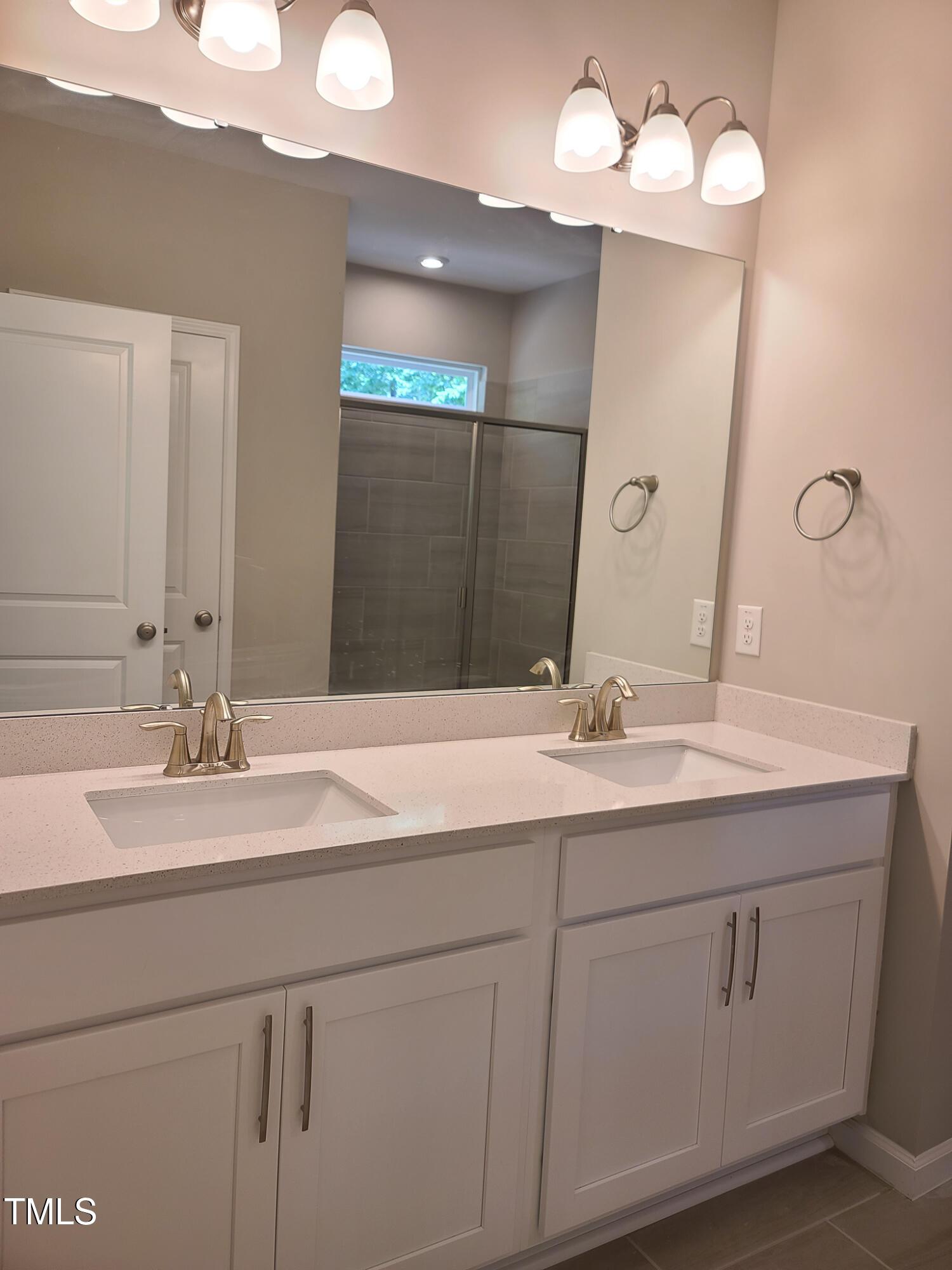 154 Black Cloud Drive Louisburg, NC 27549 - Photo 13 of 28 a bathroom with a sink vanity and a mirror