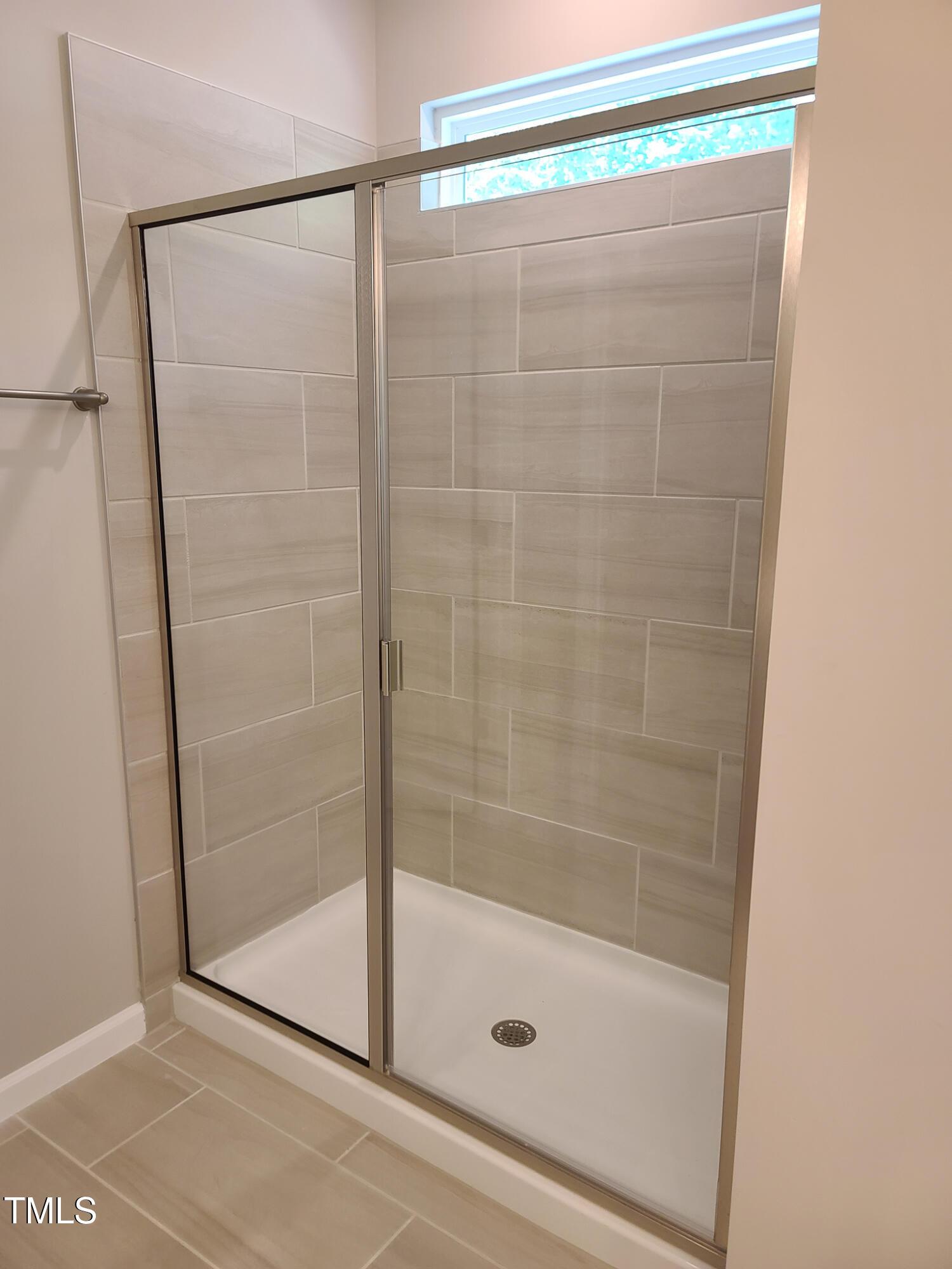 154 Black Cloud Drive Louisburg, NC 27549 - Photo 15 of 28 a bathroom with a glass shower door