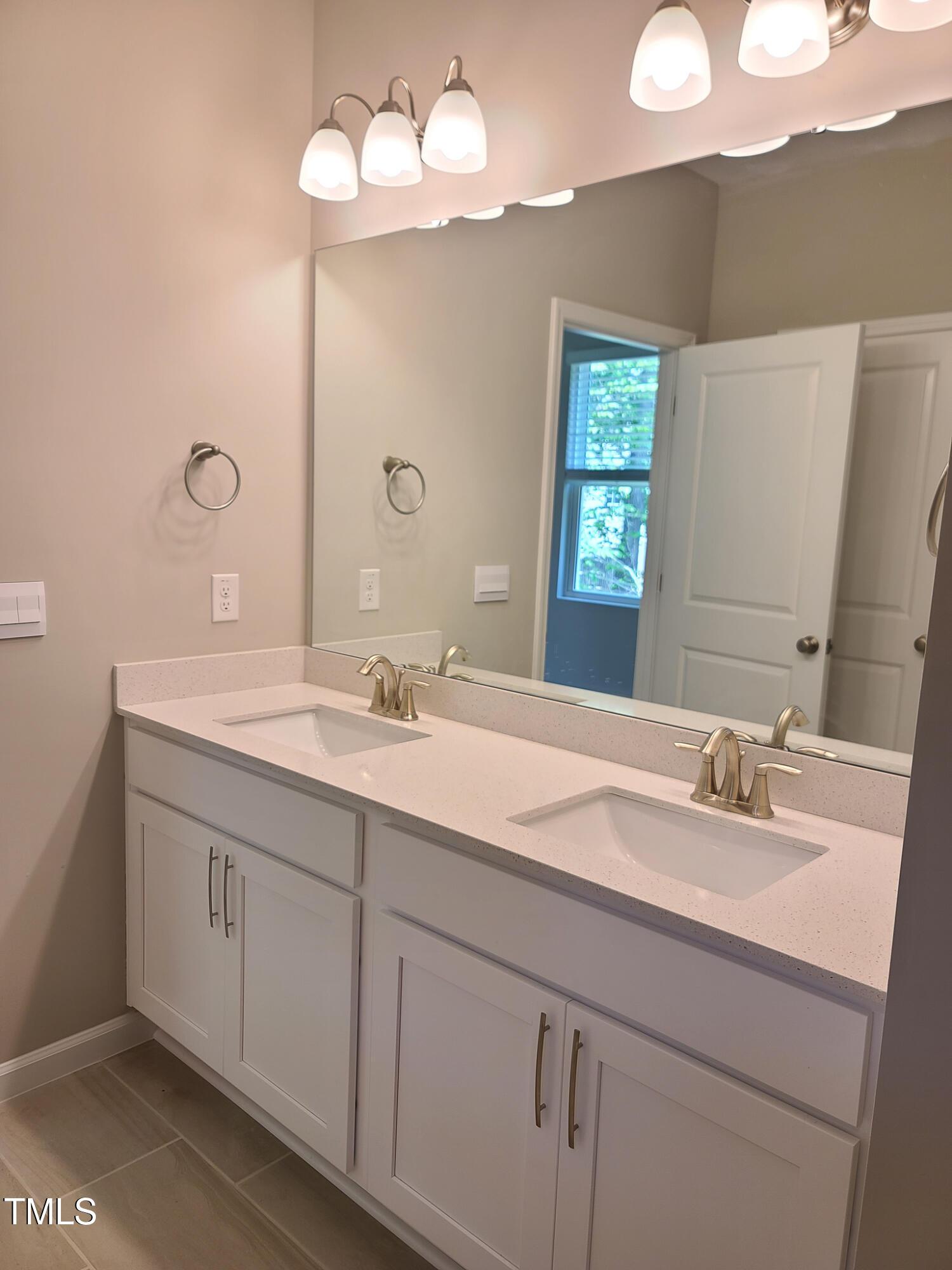 154 Black Cloud Drive Louisburg, NC 27549 - Photo 16 of 28 a bathroom with a sink vanity and a mirror