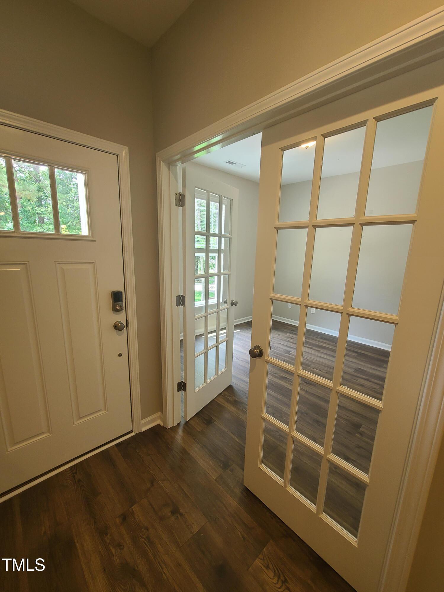 154 Black Cloud Drive Louisburg, NC 27549 - Photo 2 of 28 a view of an empty room with wooden floor and a window
