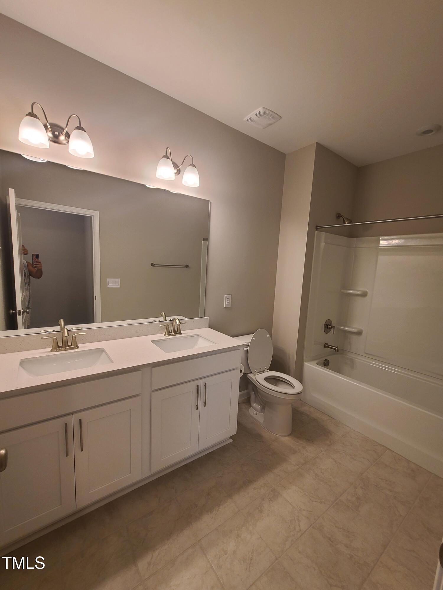 154 Black Cloud Drive Louisburg, NC 27549 - Photo 21 of 28 a bathroom with a double vanity sink and a mirror