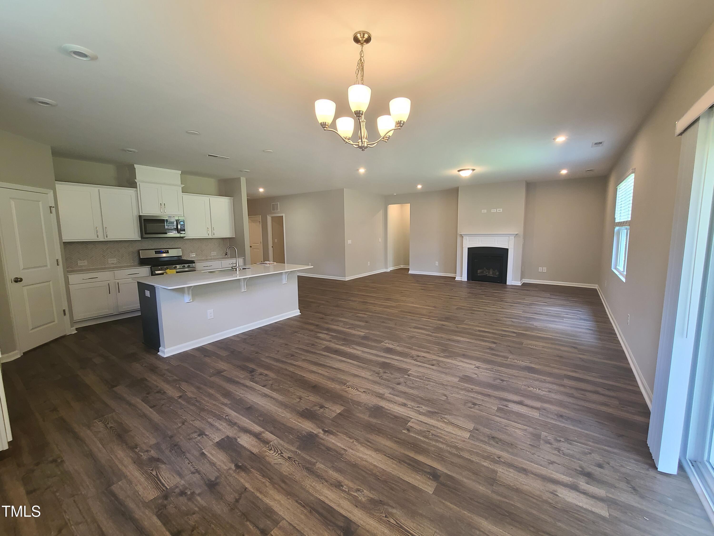 154 Black Cloud Drive Louisburg, NC 27549 - Photo 5 of 28 a view of a kitchen with a sink cabinets and wooden floor