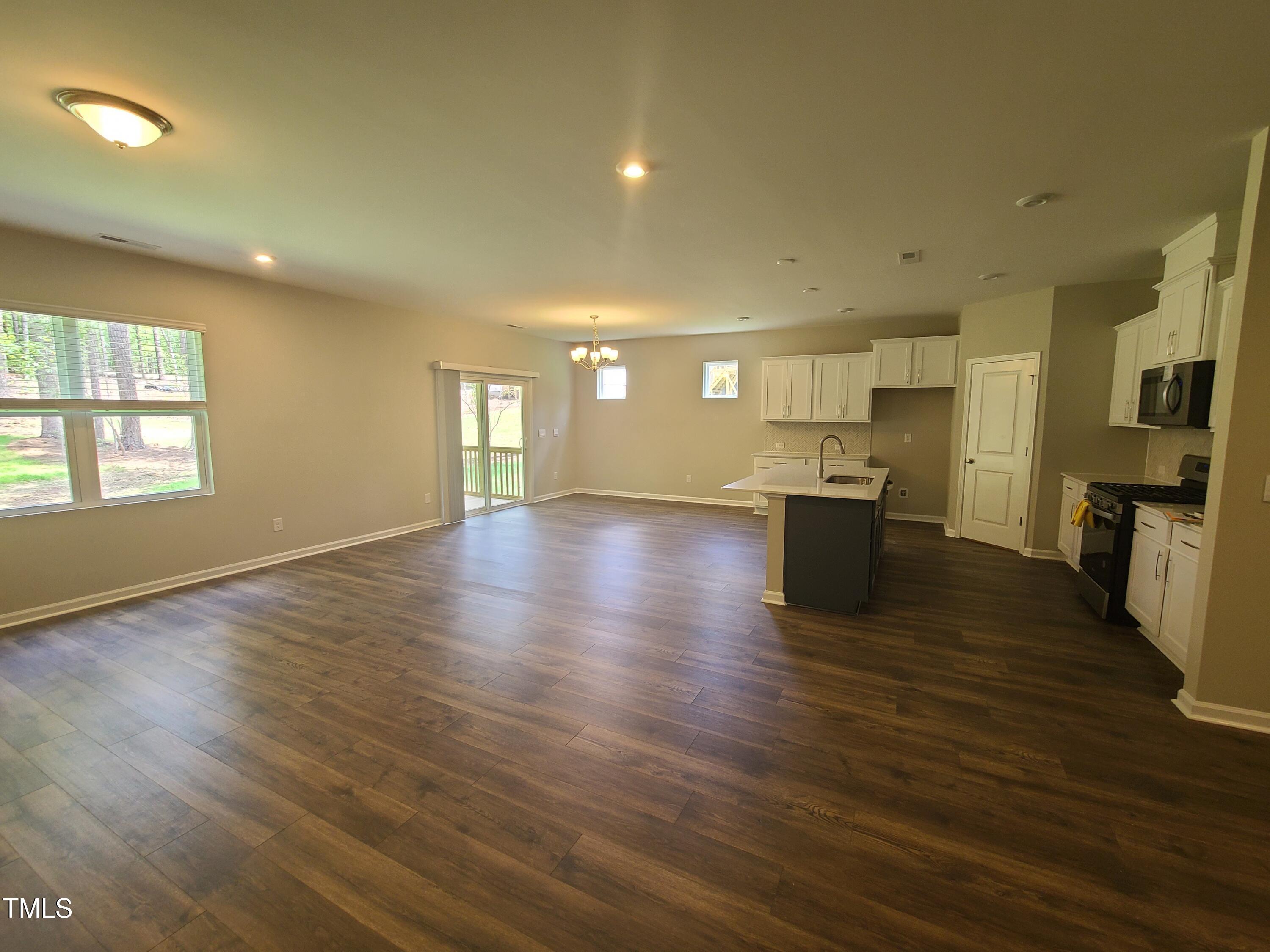 154 Black Cloud Drive Louisburg, NC 27549 - Photo 7 of 28 a view of kitchen with cabinets and wooden floor