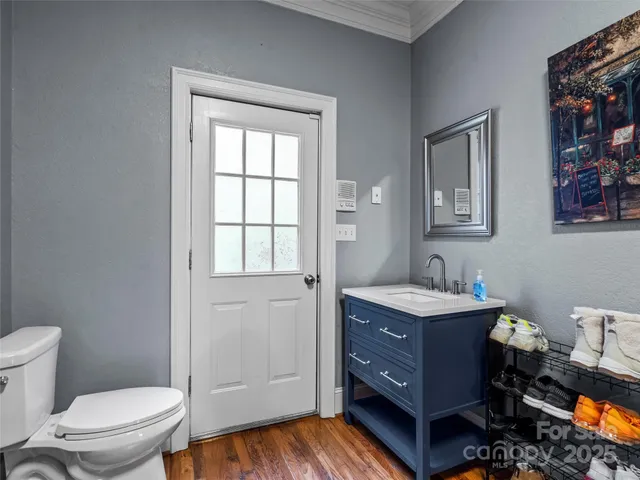 a bathroom with a toilet a sink a vanity and mirror