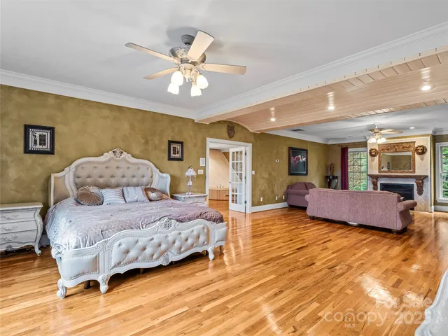 a spacious bedroom with a bed and a chandelier