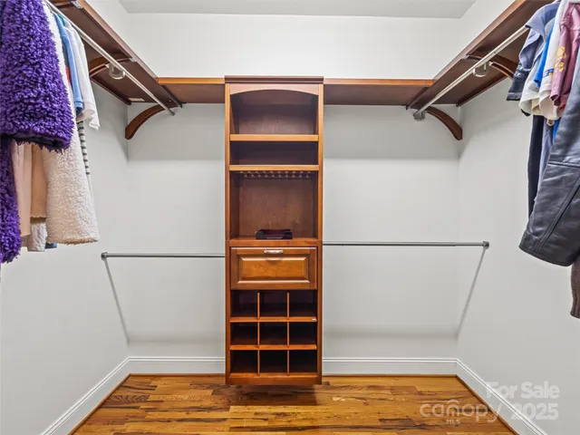 a view of walk in closet with empty racks