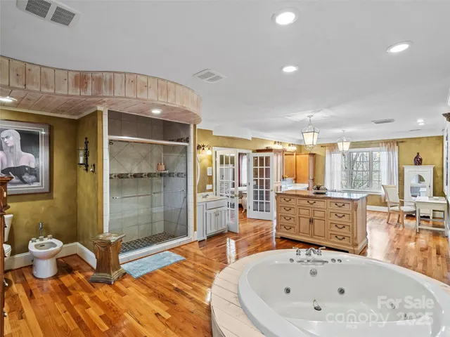 a bathroom with a tub sink and mirror