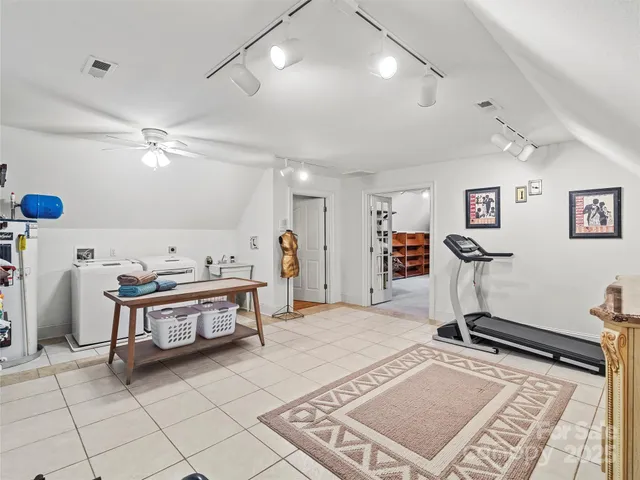 a living room with furniture a flat screen tv and a table