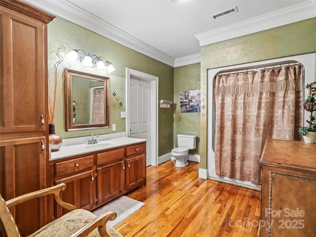 a spacious bathroom with a double vanity sink a mirror and a shower